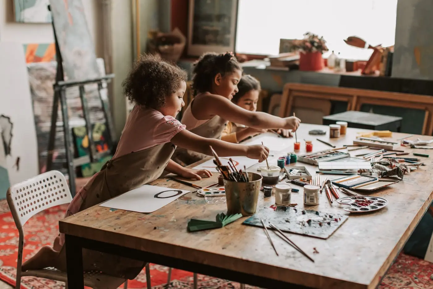 A child's hands covered in bright paint during craft time