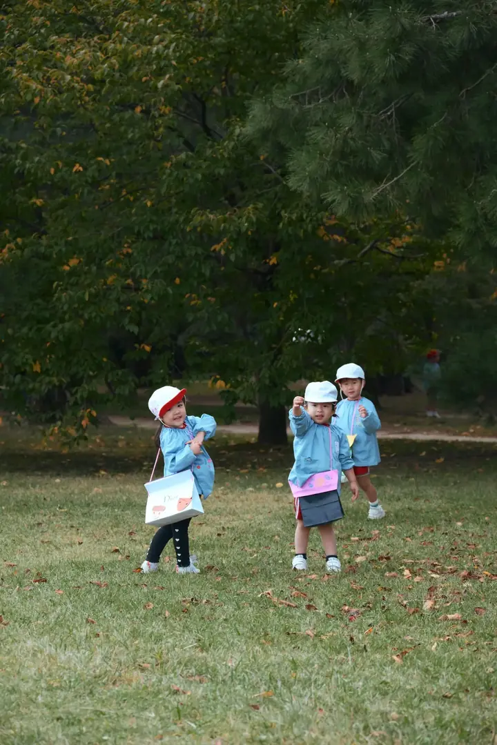 Children enjoying outdoor playtime among the trees